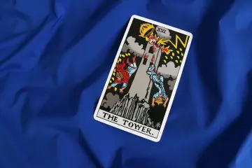 Karta **wieża tarot** przedstawia płonącą wieżę, z której spadają ludzie. Symbolizuje nagłe zmiany i destrukcję.